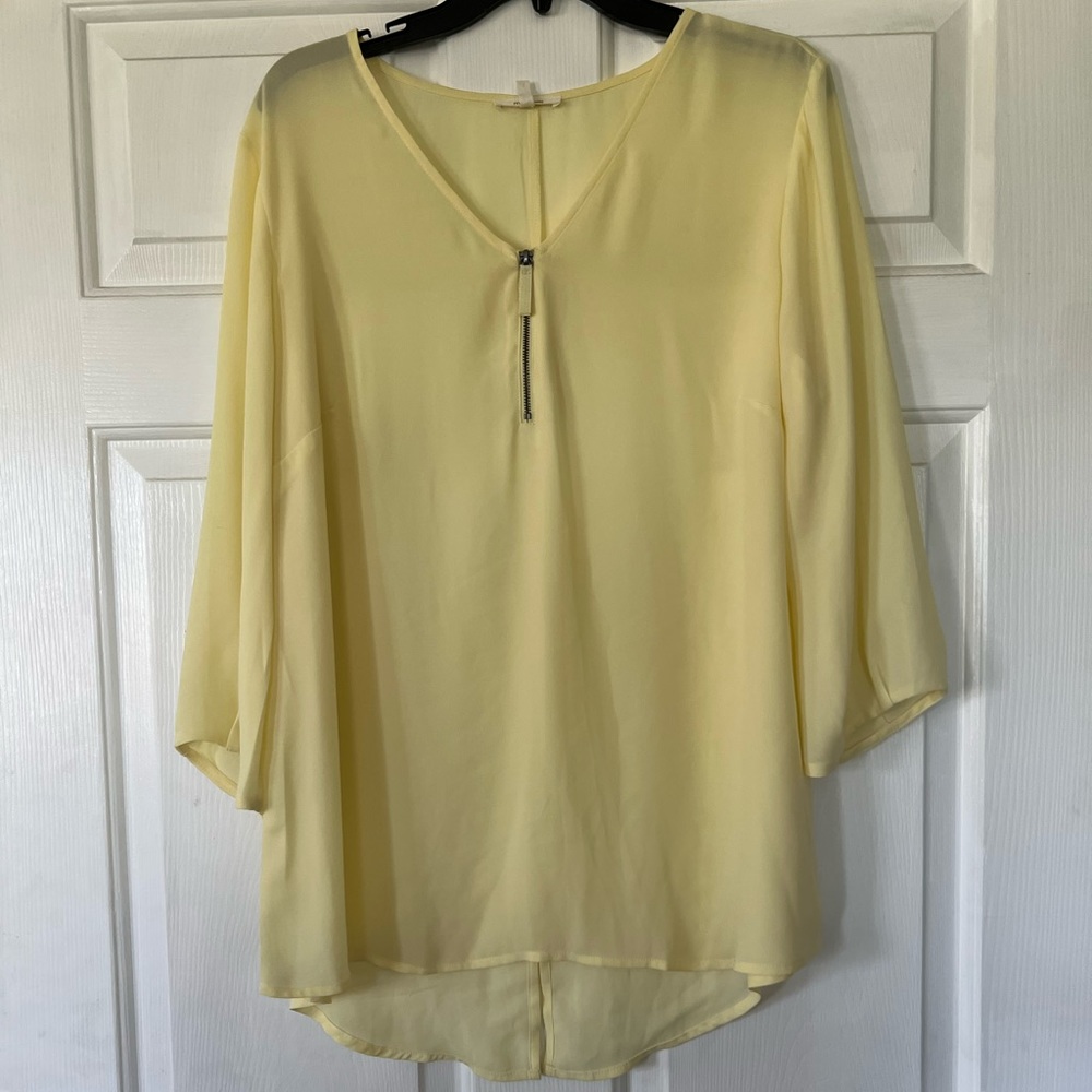 Pale yellow sheer 3/4 length sleeve top with zipper.